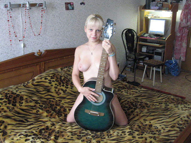 Блонда с огромным бюстом трогает гитару 6 фотография